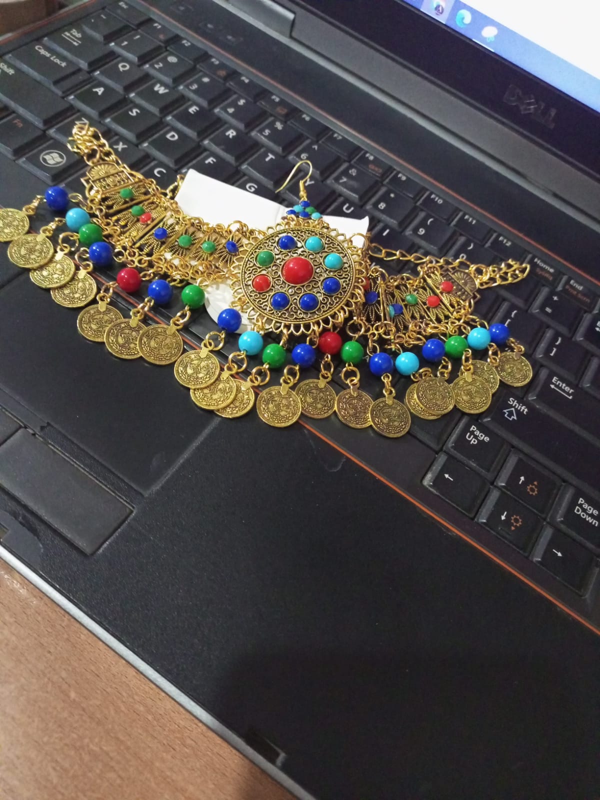 Charming Golden Color Necklace, Earrings and Matha Tikka with beautiful White, Green and Maroon Color Pearls for Special Occasion